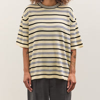 Person wearing a striped shirt against a plain background