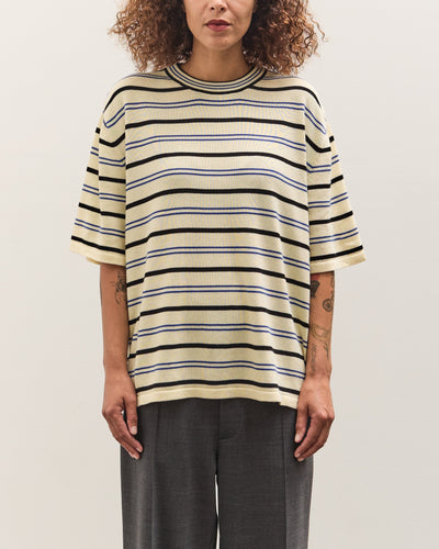 Person wearing a striped shirt against a plain background
