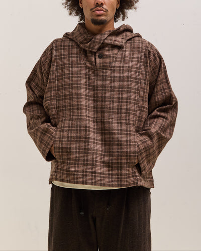 Person wearing a brown plaid hoodie against a plain background