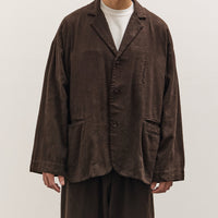 Man wearing a brown jacket and pants on a white background