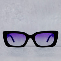 Black sunglasses with purple lenses on a light gray background