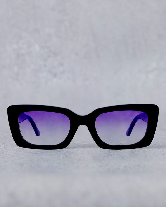 Black sunglasses with purple lenses on a light gray background